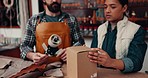 Packing, leather and people with box at a shop for an export, manufacturing or service together. Small business, retail and a man, woman or employees with cargo from production for a gift or shipping