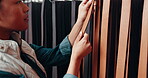 Leather workshop, belt and hands of woman in textile choice at small business. Tannery, strap and craft of tailor in factory for manufacturing, fashion production and creative work of professional