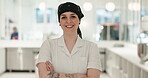 Face, chef and happy woman with arms crossed in kitchen at restaurant of hotel cafe. Portrait, cooking and smile of confident worker, culinary expert and professional employee in bandana in Canada