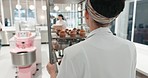Chef, woman and walking with muffins to restaurant for service, hospitality and breakfast from kitchen. Bakery, person and professional in food industry with lunch for cafe, coffee shop or business