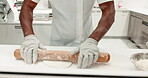 Hands, rolling pin and chef with dough on a restaurant kitchen counter for cooking job. Closeup of a professional person working with food at work for pastry, pizza or baking recipe for a bakery