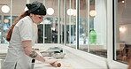 Chef, woman and rolling pin with dough in restaurant or bakery kitchen table for cookies, cooking or pizza. Professional, person and roller for pastry to bake cake, food or dessert in a diner