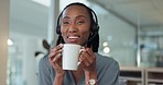 Happy black woman on coffee break at desk in call center, peace and calm in telemarketing office. Smile, relax and drink, tea time for customer support consultant at workplace with cup and headset.