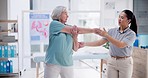 Senior patient, physiotherapy and stretching muscle, workout support or fitness in physical therapy or healthcare clinic. Medical nurse, doctor or physiotherapist helping an elderly woman with elbow