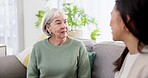 Senior woman, discussion and couch with daughter, bonding and mother together with love and mom. Home, conversation and retirement on a sofa with story, lounge and communication with elderly person