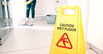 Wet, floor and sign for caution, cleaning and attention for safety in room with maid, housekeeping and risk of falling on ground. Cleaner, warning and janitor with mop, water and bucket for hygiene