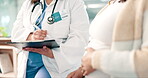 Hands, pregnant and a doctor with a patient for insurance in the hospital closeup for consulting at an appointment. Mother, questions and healthcare with a woman talking to a medicine professional