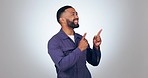 Pointing, happy and man in a studio with mockup for marketing, promotion or advertising. Smile, excited and young male person from Mexico with show hand gesture for mock up space by white background.