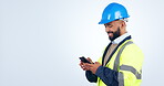 Engineering, man and phone for construction chat, communication and project management in studio. Contractor or builder typing on smartphone for architecture update and mockup on a white background