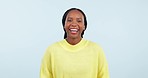 Face, funny and black woman with a smile, laughing and cheerful girl on a blue studio background. Portrait, African person and model with humor, joke and comedy with mockup space, energy and freedom