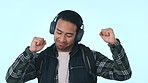 Happy asian man, headphones and listening to music or podcast against a studio background. Male person smile, dancing and enjoying audio streaming, sound track or song playlist on headset on mockup