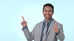 Thumbs up, pointing and business man on blue background for promotion, advertising and deal. Mockup, happy and portrait of worker with hand gesture for approval, agreement and showing in studio