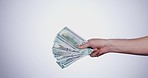 Hand, payment and closeup of cash in a studio for retail shopping, paying bills or debt. Mockup, paper money and zoom of person with bank notes for buying products isolated by white background.