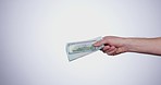 Hand, payment and closeup of money in a studio for retail shopping, paying bills or debt. Mockup, paper cash and zoom of person with bank notes for buying products isolated by white background.