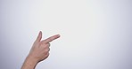 Hand, pointing and person in studio with mockup space for advertising, promotion or marketing. Finger, closeup and man model with show or presentation gesture for empty mock up by white background.