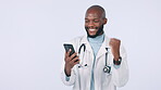 Excited, doctor and a black man with a phone for success, communication or a healthcare win. Happy, motivation and an African surgeon with celebration of a promotion on a mobile and white background