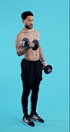 Dumbbell, workout and man with fitness training and exercise for healthy mindset, body and benefits. Personal trainer, person and athlete on blue background for wellness, muscle and cardio in studio