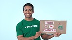 Sustainability, poster for recycling and a volunteer man on a blue background in studio to promote conservation on earth day. Portrait, smile and green charity for global warming or climate change