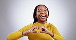 Black woman, heart hands and face, laughing and support with love sign isolated on white background. Happiness, funny and health with care, emoji and mockup space, portrait and charity in a studio