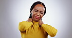 Neck pain, woman and injury in studio with stress, tired joints and arthritis risk on grey background. Sick african model massage shoulder muscle for first aid, emergency and frustrated with fatigue 