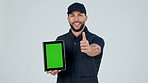 Delivery man, tablet and thumbs up for green screen with logistics, success and option on menu or pointing to services. Mobile app, ux or portrait of courier with ecommerce, tech and agreement online