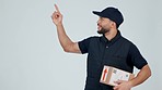 Delivery man, pointing at supplier menu and package, thumbs up with service info and advertising on white background. Box, supply chain and e commerce with courier choice and distribution in studio