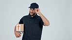 Delivery driver, man and greet with smile and box in hand for package service and transport in studio. Logistics, person and cargo pointing for distribution of order and stock on white background