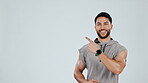 Man, face and presentation with gym advertising and fitness, smile while pointing at news on white background. Portrait, mockup space and health, branding for sports and exercise offer in studio