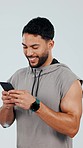 Fitness, phone and man typing in studio after exercise, training and workout for wellness. Sports, happy and person on smartphone for social media, online chat and mobile app on gray background