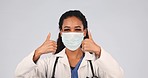 Face, woman and doctor with mask, thumbs up and healthcare safety in studio. Portrait, happy medical worker and show support, like emoji and yes sign with ppe for virus protection on white background