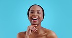 Skincare, facial and black woman face with laughing, smile and dermatology in studio. Blue background, happy African female person and skin glow with cosmetics and makeup with wellness and beauty