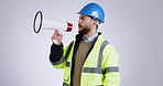 Megaphone, construction worker and announcement with speaker and attention in a studio. Engineer, man and architect with builder speech and talking for safety warning with grey background and job