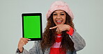 Green screen, tablet and woman pointing for review of mobile app with hand gesture isolated in studio white background. Promotion, deal and person with showing yes, like and ok symbol for website