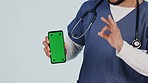 Nurse, mobile green screen and yes hand for healthcare website, clinic excellence or okay emoji in studio. Medical person or doctor, phone and telehealth services, tracking marker on white background