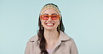 Happy, fashion sunglasses and face of woman confident in casual clothes, trendy apparel or stylish outfit. Happiness, fashionable style and portrait of person with studio glasses on blue background