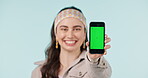 Woman, hand and green screen with phone for presentation of information, announcement or news on social media. Cellphone, mockup and smile on face for promotion on mobile app, ux or gen z show ui 
