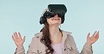 Smile, virtual reality glasses and woman with metaverse, futuristic and technology on a blue studio background. Person, girl and model with VR eyewear, augmented reality and digital app with gaming