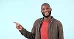 Pointing, smile or face of black man by offer, discount deal or retail sale on studio space or logo advertising. Happy, show or excited person with mockup, news or menu promotion on blue background