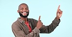 Mockup, smile and black man pointing up at space in studio isolated on a blue background. Portrait, happy person and hands for advertising presentation, marketing offer and show commercial promotion