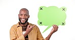 Happy black man, speech bubble and pointing to mockup in advertising against a studio background. Portrait of African male person smile showing shape in social media feedback, comment or question