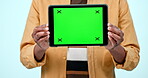 Tablet mockup, green screen display and hands in studio with website, internet and social network. Ux, ui and closeup of person with technology tracking markers, advertising or app on blue background