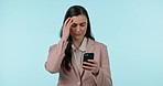 Stress, cellphone and businesswoman in a studio with headache doing medical research for pain. Frustrated, migraine and professional young female model on a phone for telehealth by blue background.