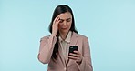 Frustrated, phone and businesswoman in a studio with headache doing medical research for pain. Stress, migraine and professional young female model on a cellphone for telehealth by blue background.