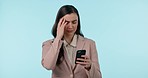 Stress, phone and businesswoman in a studio with headache doing medical research for pain. Frustrated, migraine and professional young female model on a cellphone for telehealth by blue background.