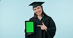 Pointing, graduation and a woman with a green screen tablet for education or digital certificate. Happy, face portrait and a female graduate with mockup on tech for success on a studio background