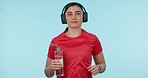 Running, fitness and face of woman with music, headphones and water bottle in studio for training on blue background. Exercise, portrait and lady runner with radio, earphones or podcast workout audio
