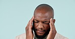 Businessman, headache and black man in studio with pain and burnout from corporate job and mental health. Face, person and stress with anxiety and brain fog from audit career on blue background