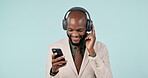 Business man, phone and dancing with headphones in studio internet, energy and app. Happy, smartphone and a professional person from Kenya on a blue background listening or streaming music online