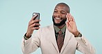 Business, video call and black man with a smartphone, greeting and accountant on a blue studio background. African person, happy employee and investor with a cellphone, hello and wave with connection