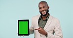 Tablet, green screen and business man presentation, advertising mockup and website design space in studio. Face of African person of career, digital technology and tracking marker on blue background